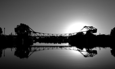 Walnut Grove Bridge taken from dock with sun setting behind.