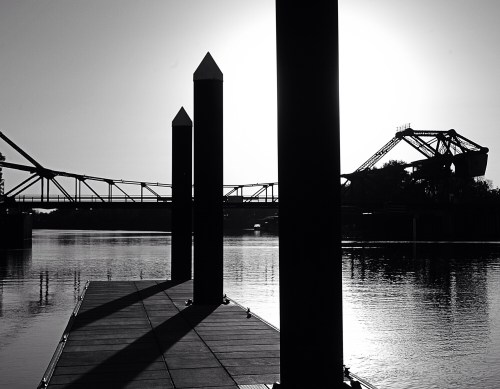 Boat dock at Walnut Grove with bridge beyond.